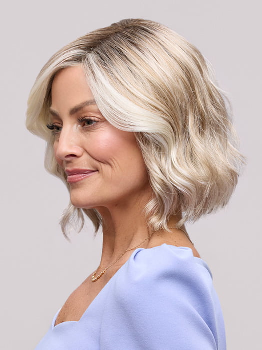 Model is wearing JANUARY PETITE by JON RENAU in color 101/88/27S8 CATALINA BLONDE | Pale blonde with Pure White Natural Violet halo highlights, shaded medium brown