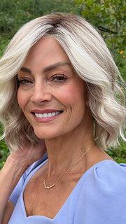 Model is wearing JANUARY PETITE by JON RENAU in color 101/88/27S8 CATALINA BLONDE | Pale blonde with Pure White Natural Violet halo highlights, shaded medium brown