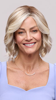 Model is wearing JANUARY PETITE by JON RENAU in color 101/88/27S8 CATALINA BLONDE | Pale blonde with Pure White Natural Violet halo highlights, shaded medium brown