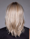 Model is wearing MONACO by BELLETRESS in color MILKSHAKE BLONDE R | A mixture of Light Sandy Brown, Highlighted with Light Ash Blonde with a Hint of Light Platinum Blonde with a Medium Root Color