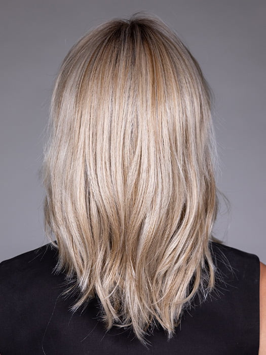 Model is wearing MONACO by BELLETRESS in color MILKSHAKE BLONDE R | A mixture of Light Sandy Brown, Highlighted with Light Ash Blonde with a Hint of Light Platinum Blonde with a Medium Root Color