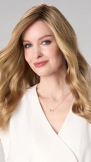 Model is wearing MAYA HAND TIED by ENVY in color SPARKLING CHAMPAGNE | Medium Brown roots with overall Strawberry Blonde base and soft Golden Blonde highlights