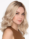 Model is wearing MOLLY by ENVY in SILKY BEIGE | Light Platinum Blonde with Dark Brown Roots
