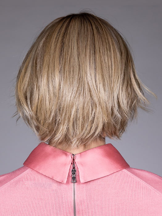 Model is wearing OSLO by BELLETRESS in color RAW SUGAR BLONDE | A Neutral Light Blonde, Honey Blonde, Pale Gold Blonde, with a base of Light Brown Lowlights featuring a Medium Root Color