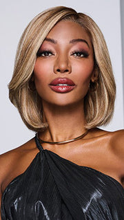 Model is wearing LONGING FOR LONDON by RAQUEL WELCH in color RH13/25SS SHADED PRALINE | Neutral Medium Blond with Medium Golden Blonde highlights that extend from dark roots to ends