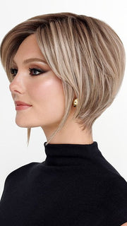 Model is wearing THE ROUGE by TRESSALLURE in color 36/25/23/R6 MOON DUST | Dark salt and pepper base with blended golden blonde and cool platinum tones, shaded with Dark Roots