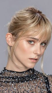 Model is wearing LEMON II by ELLEN WILLE in color SANDY BLONDE ROOTED 16.22.14 | Medium Blonde and Light Neutral Blonde with Medium Ash Blonde Blend and Shaded Roots
