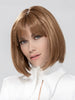 Model is wearing MISS COMFORT by ELLEN WILLE in color ALMOND BROWN ROOTED 830.9 | Medium Brown, Light Auburn and Medium Warm Brown Blend with Shaded Roots