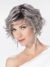 Model is wearing ROMANCE DELUXE by ELLEN WILLE in color METALLIC GREY ROOTED 60.51 | Pearl White, Darkest/Lightest Brown with Grey Blend with Shaded Roots