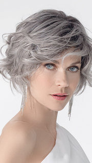 Model is wearing ROMANCE DELUXE by ELLEN WILLE in color METALLIC GREY ROOTED 60.51 | Pearl White, Darkest/Lightest Brown with Grey Blend with Shaded Roots