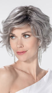 Model is wearing ROMANCE DELUXE by ELLEN WILLE in color METALLIC GREY ROOTED 60.51 | Pearl White, Darkest/Lightest Brown with Grey Blend with Shaded Roots