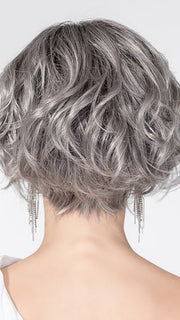 Model is wearing ROMANCE DELUXE by ELLEN WILLE in color METALLIC GREY ROOTED 60.51 | Pearl White, Darkest/Lightest Brown with Grey Blend with Shaded Roots