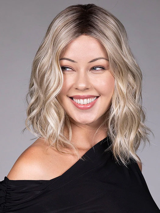 Model is wearing ANDIE in color BUTTER BEER R | A rich blend of warm brunette and golden honey highlights finished with a soft, natural root.