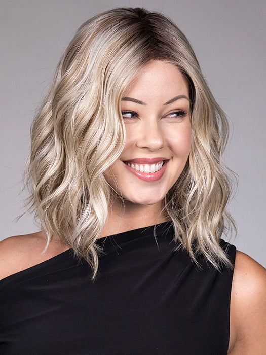 Model is wearing ANDIE in color BUTTER BEER R | A rich blend of warm brunette and golden honey highlights finished with a soft, natural root.