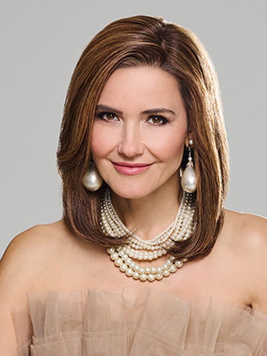 Model is wearing MIDNIGHT IN PARIS by RAQUEL WELCH in color RH8 8/29SS SHADED HAZELNUT | Warm Medium Brown with Ginger Blonde highlights from dark roots to ends