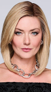 Model is wearing MIDNIGHT IN PARIS by RAQUEL WELCH in color RH14/88SS SHADED GOLDEN WHEAT | Dark Blonde Evenly Blended with Pale Blonde Highlights that extend from dark roots to ends
