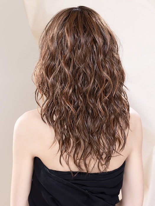 Model is wearing SERENA in BAHAMA BEIGE | Medium Honey Blonde, Light Ash Blonde, and Lightest Reddish Brown blend