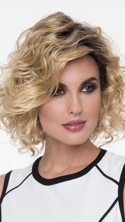 A long, side-swept bang and artfully messy curls