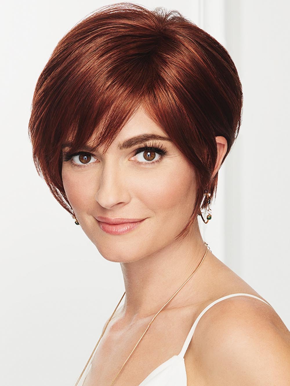 A side-swept bang, face-framing layers with tapered edges