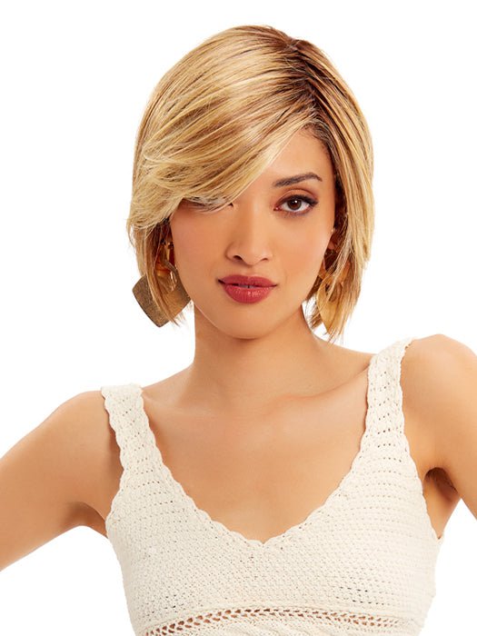 A unique bob falling above the collar that has short textured layers, beach waves and silky feathered bangs