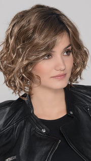 A trendy, mid length style with perfectly placed layers. The monofilament part placement offers the perfect amount of volume