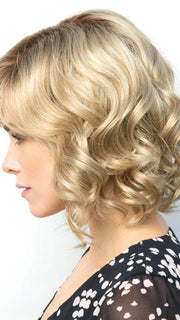 The Reign Wig by Amore is a short layered bob with tousled waves and a side-swept fringe