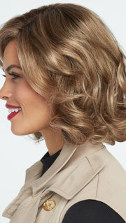 This style can be worn in a “scrunched” manner or brushed out to create a more voluminous and stylized look.