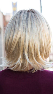 The synthetic hair is cut, styled, and ready-to-wear