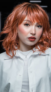 Maha host @ wigs.com/LIVE in Breezy Wavez  by Rene of Paris | Color: DUSTY-ROSE | Medium Coral Red Base with Dark Brown Roots