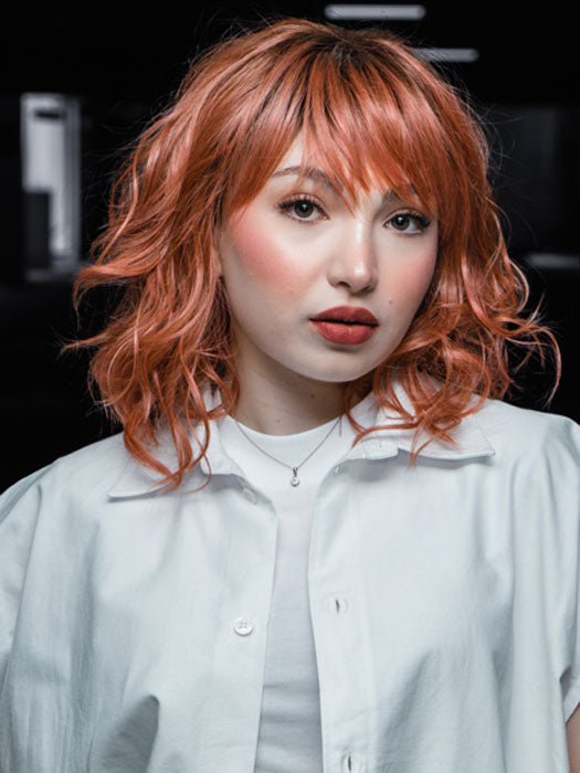 Maha host @ wigs.com/LIVE in Breezy Wavez  by Rene of Paris | Color: DUSTY-ROSE | Medium Coral Red Base with Dark Brown Roots