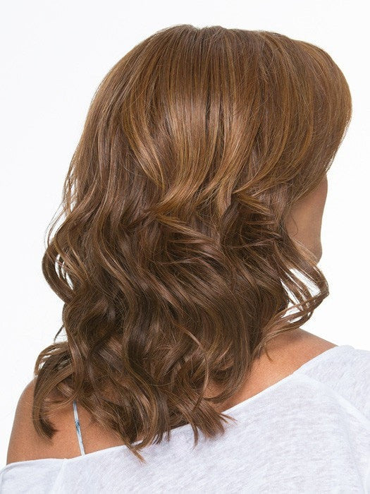 Soft silhouette with beach wave curl texture falls below the shoulders