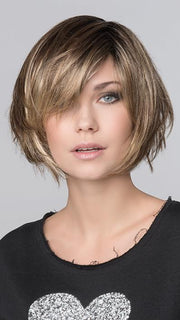 The blended fringe frames the face, creating a modern, and trendy cut