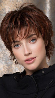 Bangs are layered and meet the brow