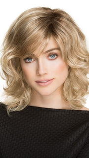 A voluminous, shoulder-length wig with a wavy texture all over