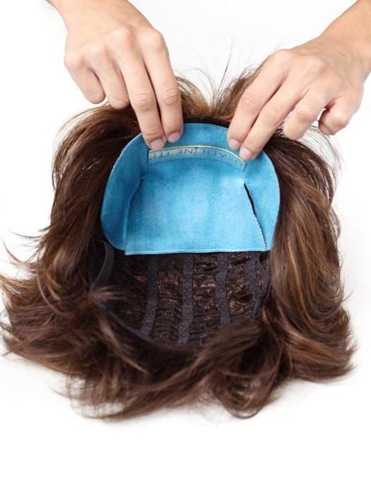 Remove the adhesive strip and apply the tan colored side to your wig, the soft blue material will touch your head and scalp.