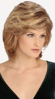 Featuring a monofilament top, this wavy synthetic hair wig allows styling versatility with a natural looking part. 