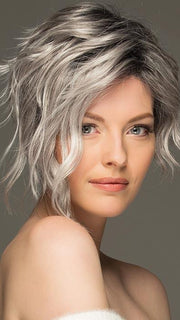 Ryan is a soft asymmetrical pixie style with long side-swept wavy bangs
