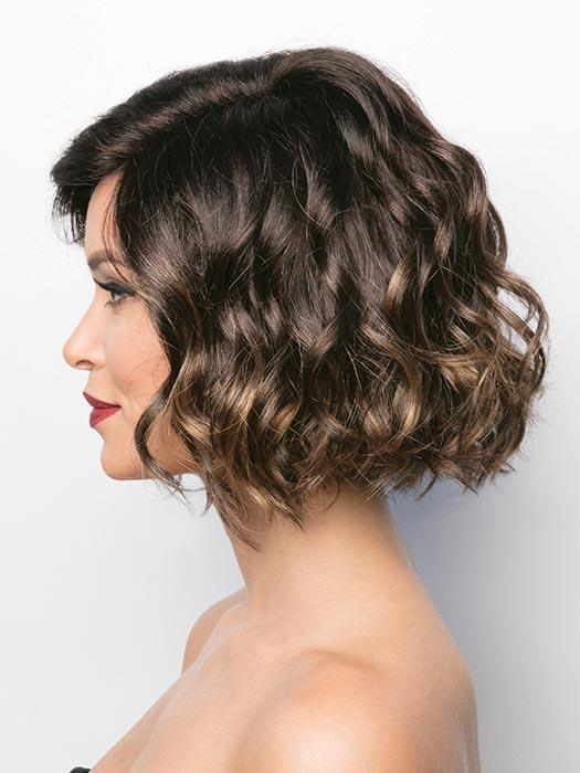 A short, flirty bob with a side swept fringe. With her tousled waves that give this style the perfect amount of volume to flatter any face shape