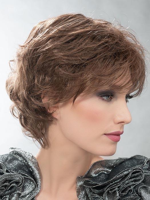 This sophisticated style features all-over layers, soft body, and curls